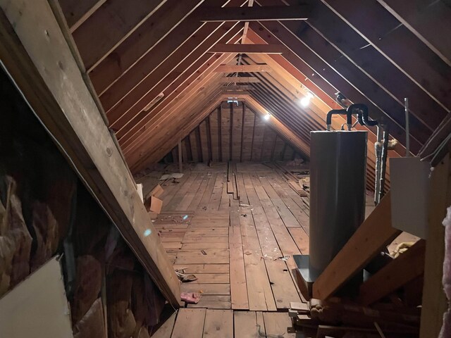 hallway with vaulted ceiling, a textured ceiling, and carpet floors