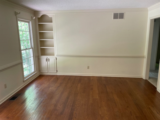 unfurnished room with built in features, dark hardwood / wood-style flooring, and a textured ceiling