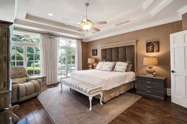 bedroom featuring ceiling fan, dark hardwood / wood-style flooring, a tray ceiling, and crown molding