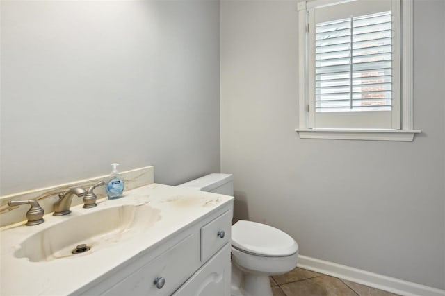 bathroom featuring tile patterned flooring, vanity, and toilet