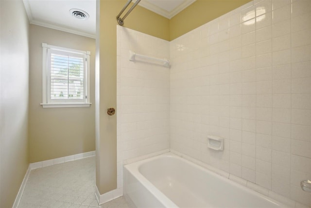 bathroom with crown molding and tiled shower / bath