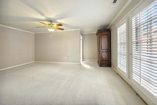 carpeted empty room featuring crown molding and ceiling fan