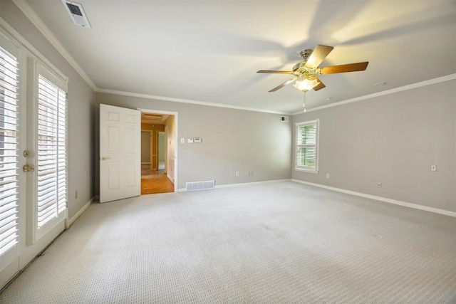 unfurnished bedroom with crown molding, light colored carpet, and ceiling fan