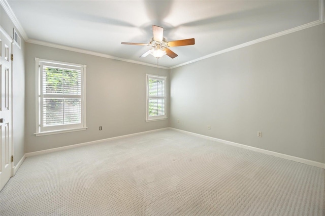 carpeted spare room featuring crown molding and ceiling fan