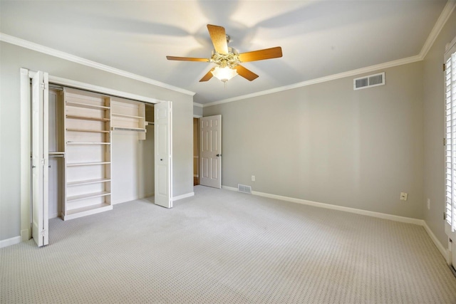 unfurnished bedroom featuring multiple windows, ceiling fan, a closet, and light carpet