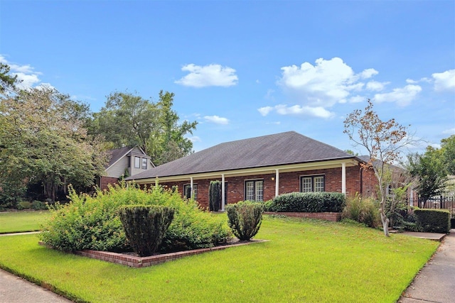 view of front of house with brick siding and a front lawn