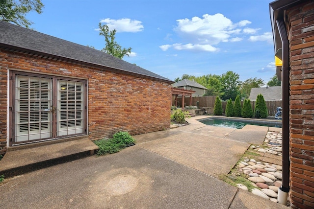 view of pool with a patio and french doors