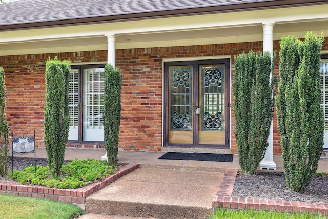 doorway to property featuring a porch and french doors