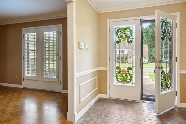 entryway with ornamental molding and a wealth of natural light