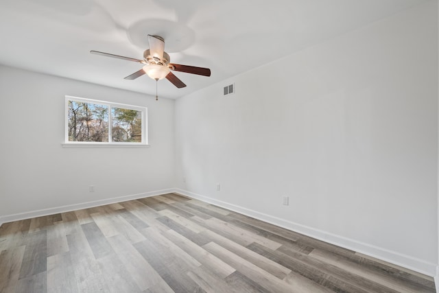 unfurnished room with ceiling fan and hardwood / wood-style floors