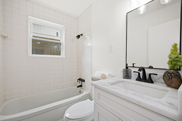 full bathroom featuring toilet, vanity, and tiled shower / bath