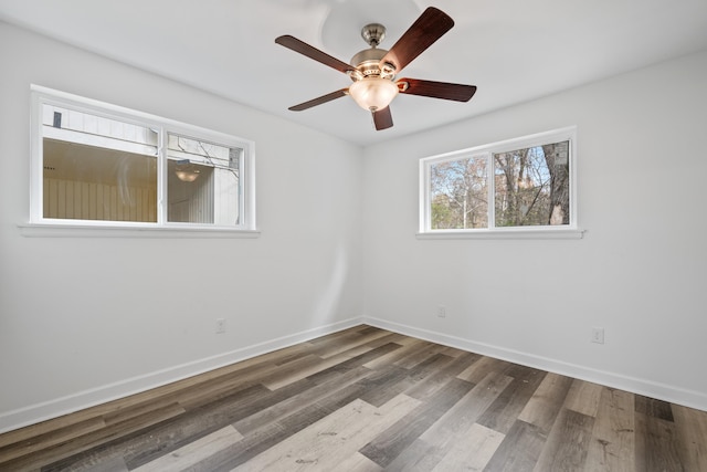 spare room with ceiling fan and dark hardwood / wood-style flooring