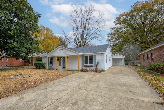 ranch-style home featuring covered porch and a garage