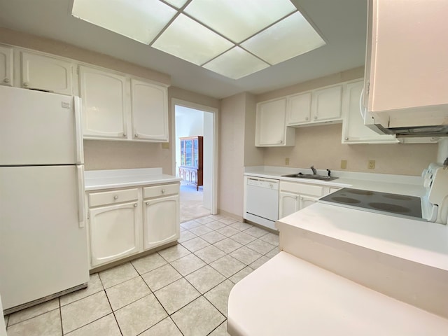 kitchen with white cabinets, sink, white appliances, and light tile patterned floors