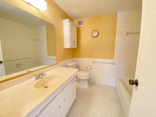 full bathroom with vanity, tile walls, tub / shower combination, toilet, and tile patterned flooring