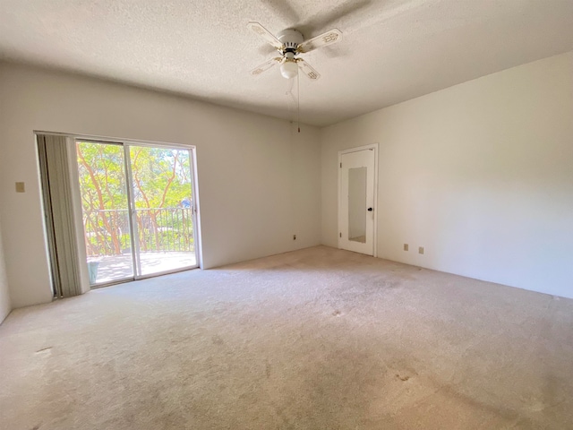 empty room with a textured ceiling, ceiling fan, and carpet flooring