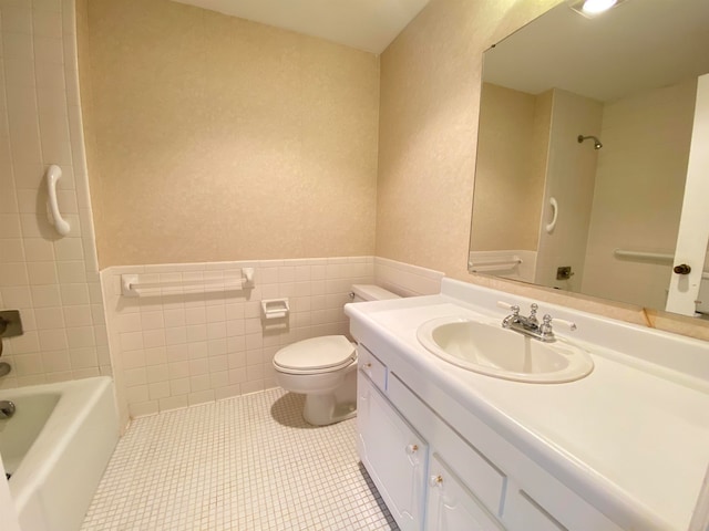 full bathroom featuring vanity, tile patterned floors, tile walls, tiled shower / bath combo, and toilet