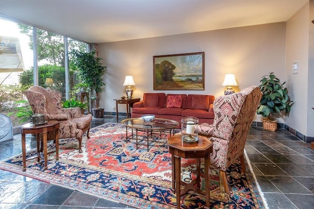 tiled living room featuring a wall of windows