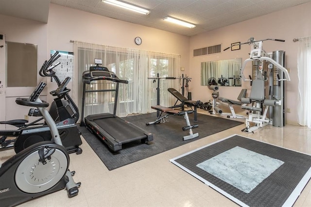 workout area featuring tile patterned flooring