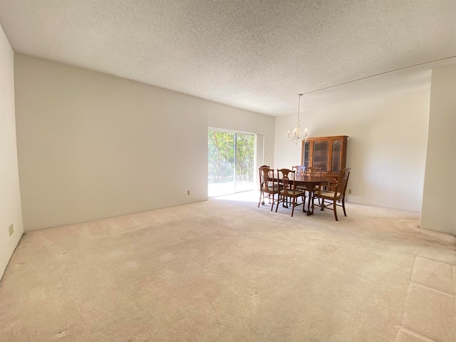 carpeted dining area featuring a textured ceiling and an inviting chandelier