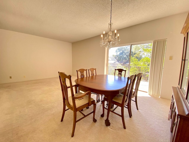 carpeted dining room featuring a notable chandelier and a textured ceiling