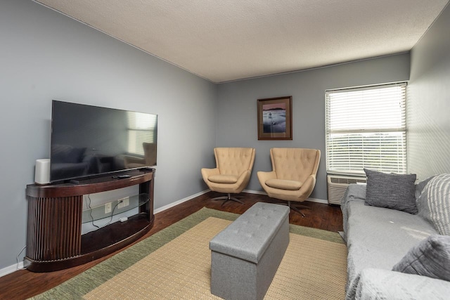 living room featuring dark hardwood / wood-style floors and a textured ceiling