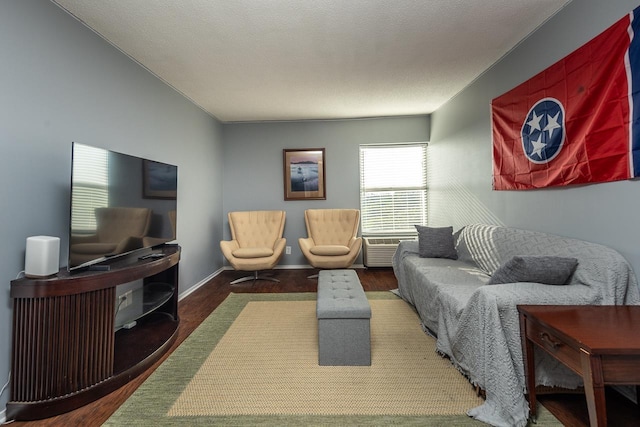 living room featuring dark wood-type flooring and a textured ceiling