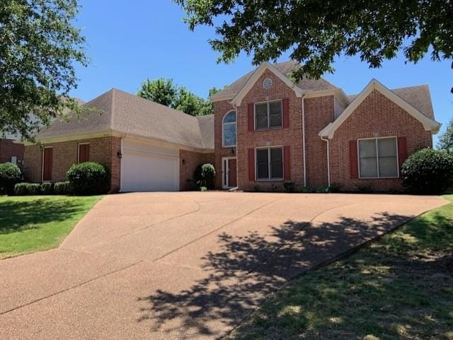 view of front of home with a garage and a front yard