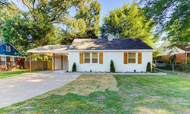 ranch-style house with a carport and a front yard