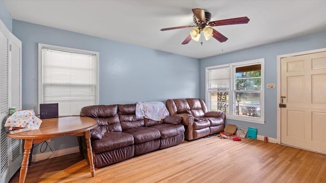 living room with light hardwood / wood-style floors and ceiling fan