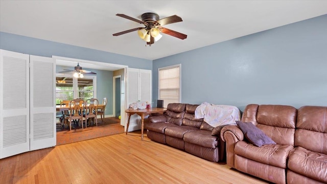 living room with ceiling fan and light wood-type flooring