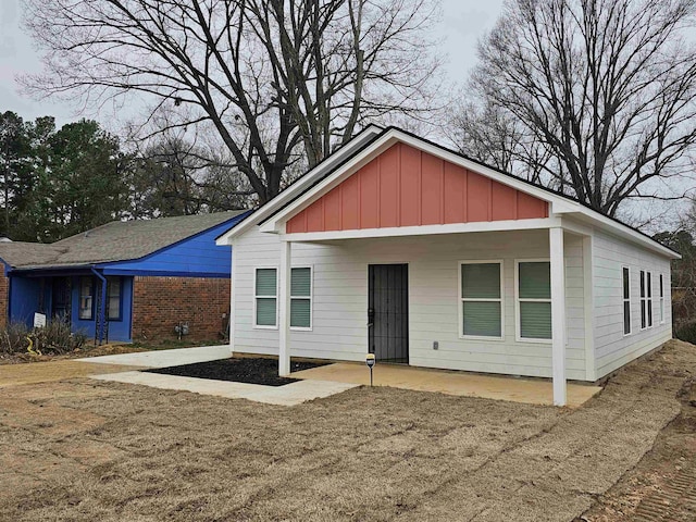 view of front facade with a patio and board and batten siding