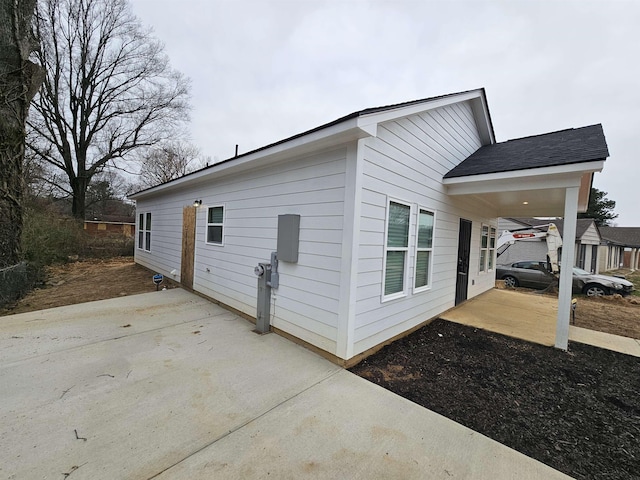 view of side of home with a patio