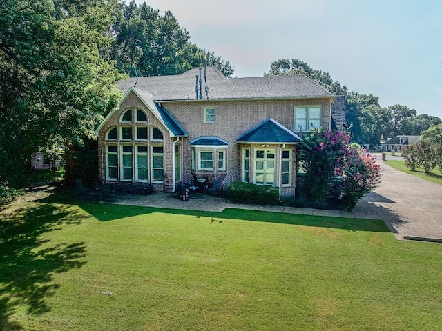 rear view of house with a lawn