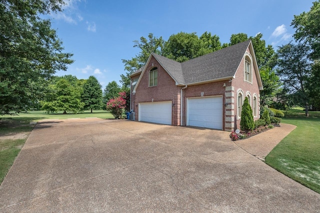 view of side of home with a garage and a lawn