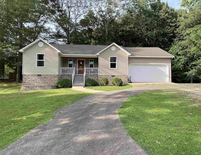 single story home featuring a porch, a garage, and a front lawn