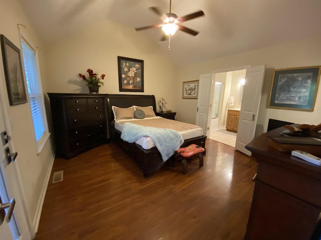 bedroom with connected bathroom, vaulted ceiling, ceiling fan, and dark wood-type flooring