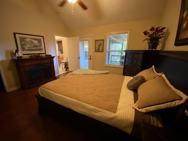 bedroom featuring dark hardwood / wood-style flooring, vaulted ceiling, and ceiling fan