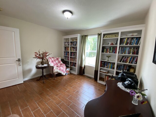 sitting room featuring a textured ceiling