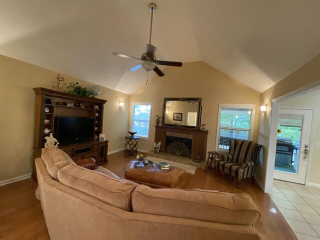 tiled living room with vaulted ceiling and ceiling fan