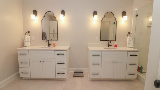 bathroom with a tile shower, tile patterned floors, and dual bowl vanity