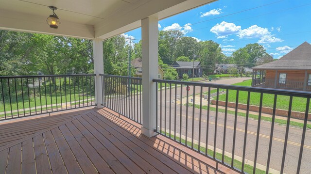 wooden deck with a lawn