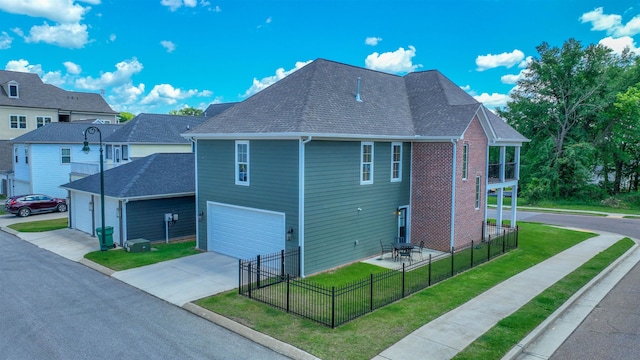 view of side of property with a garage and a yard