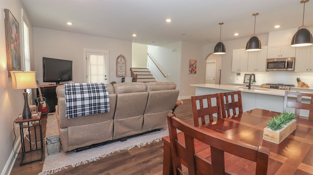 living room featuring sink and dark hardwood / wood-style flooring