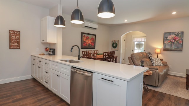 kitchen featuring dishwasher, sink, kitchen peninsula, and white cabinets