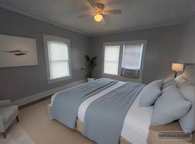 bedroom with cooling unit, multiple windows, ceiling fan, and baseboards