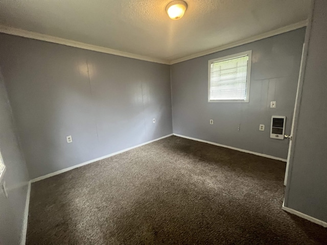 empty room featuring baseboards, heating unit, a textured ceiling, crown molding, and dark carpet