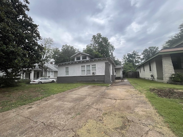 view of front of property with a front lawn and brick siding