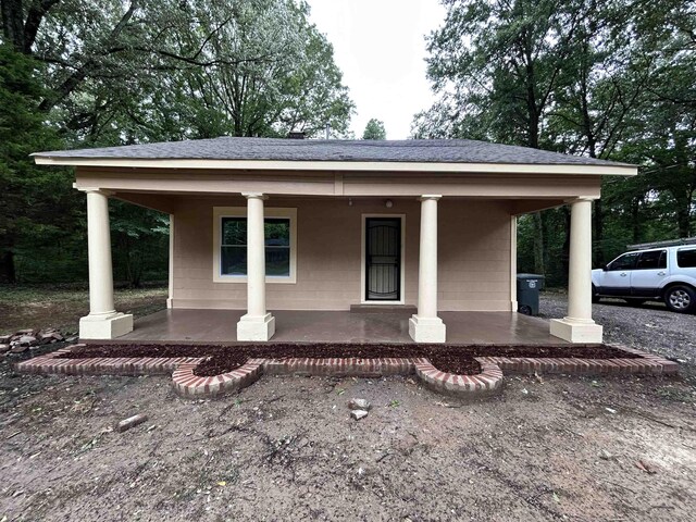 view of front of property with a porch and a carport