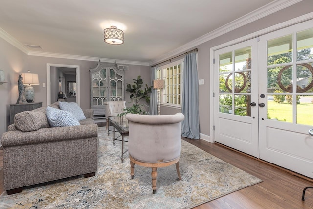 living room with french doors, hardwood / wood-style flooring, and ornamental molding